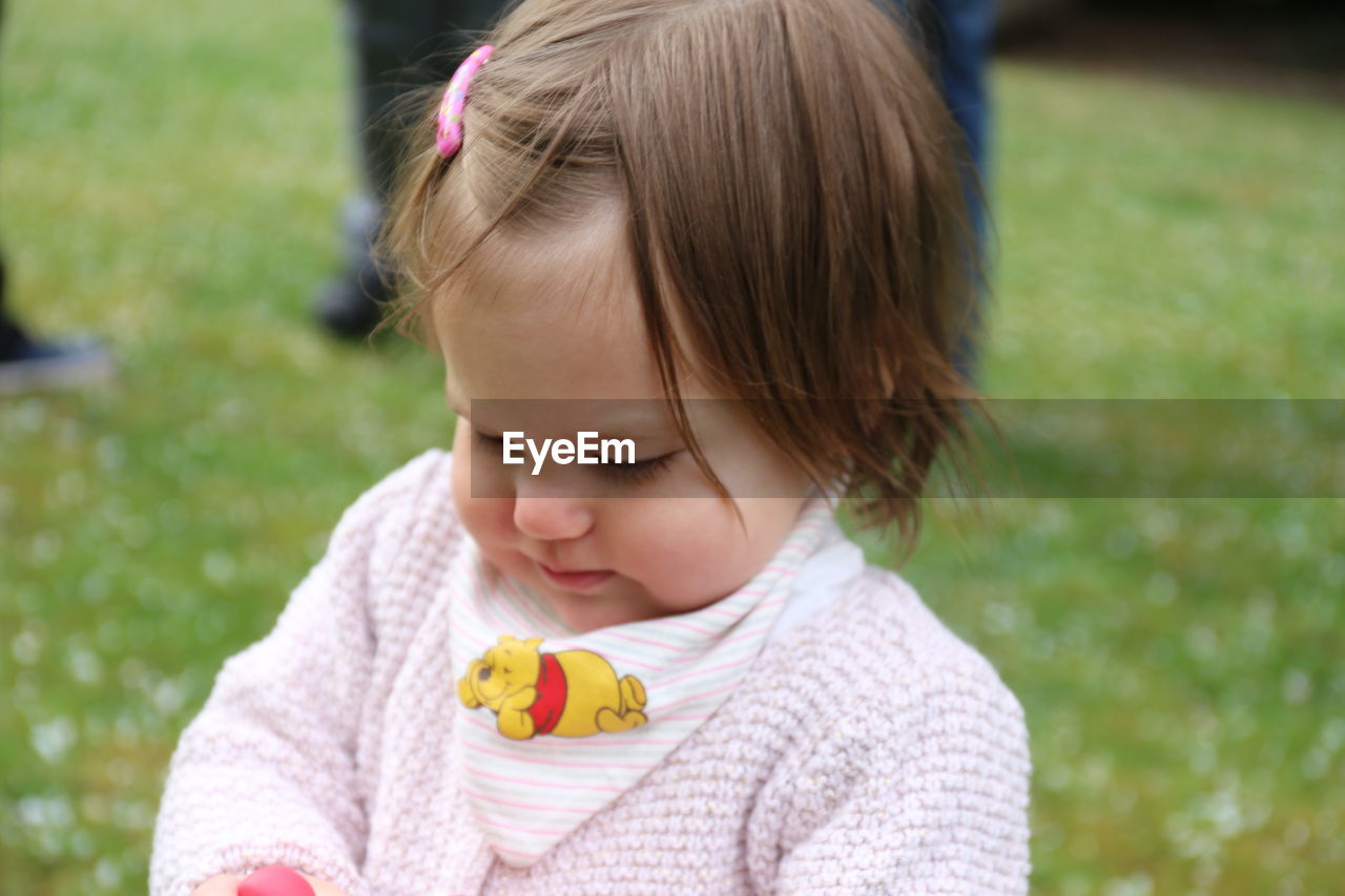 CLOSE-UP PORTRAIT OF CUTE GIRL HOLDING BABY