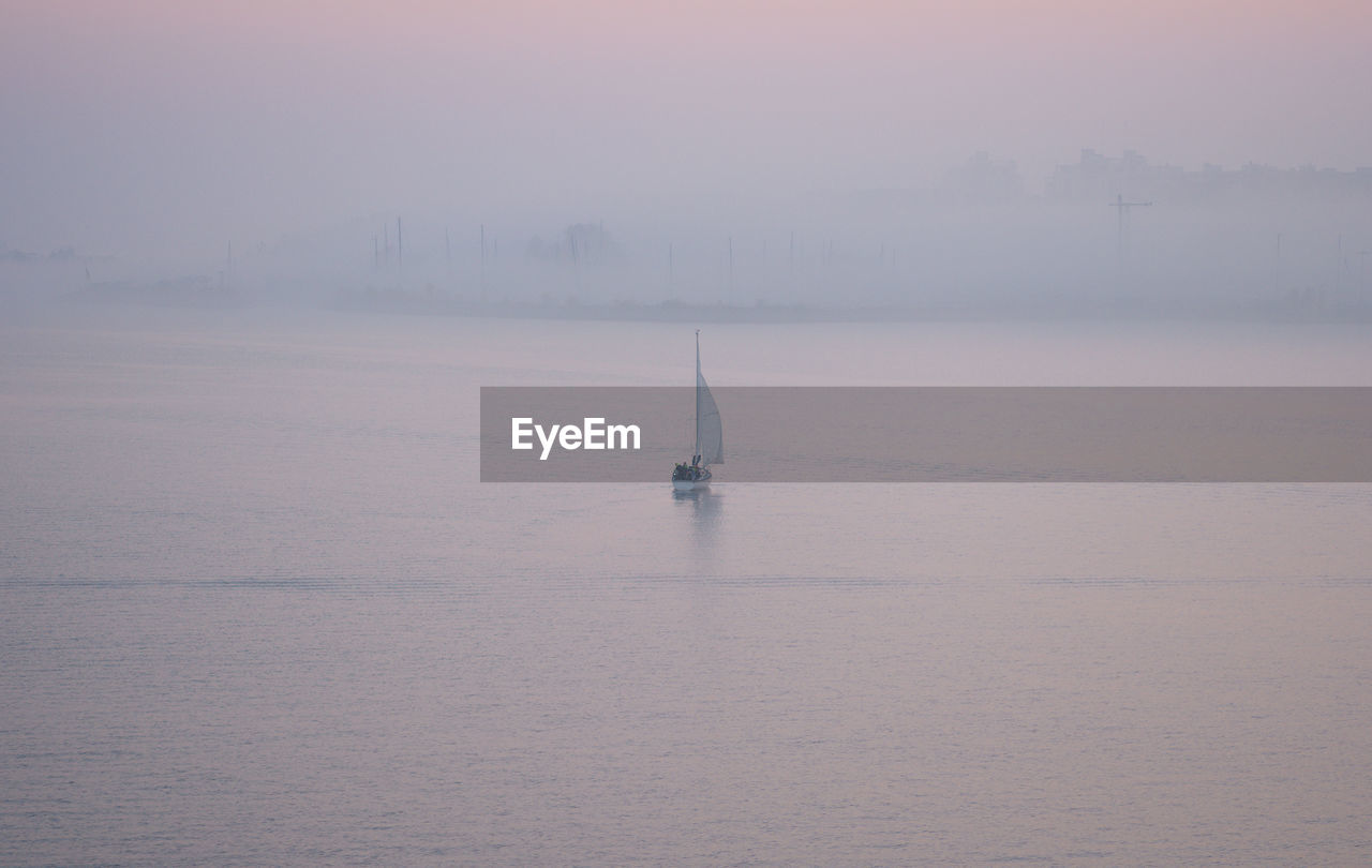 Sailboat in sea against sky during winter