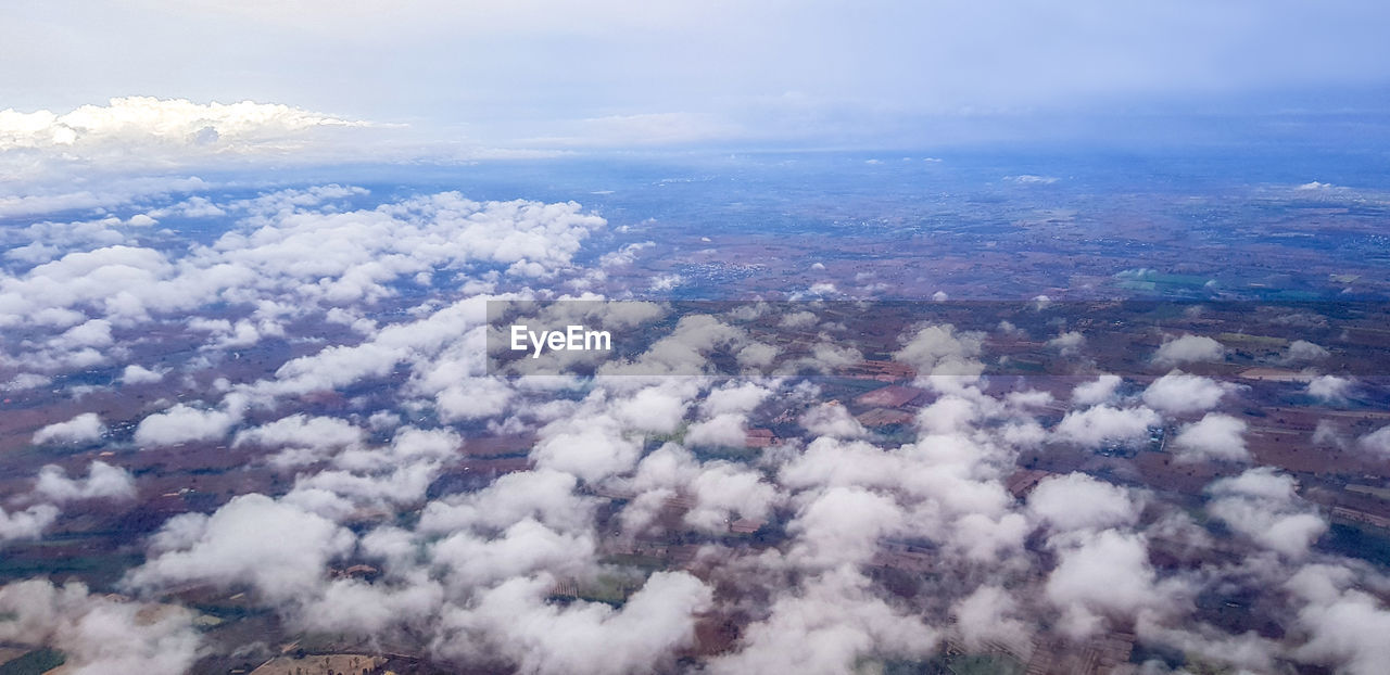 HIGH ANGLE VIEW OF CLOUDS OVER LANDSCAPE