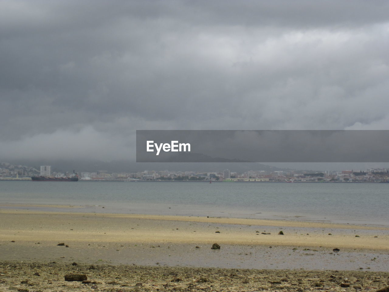 SCENIC VIEW OF BEACH AGAINST CLOUDY SKY