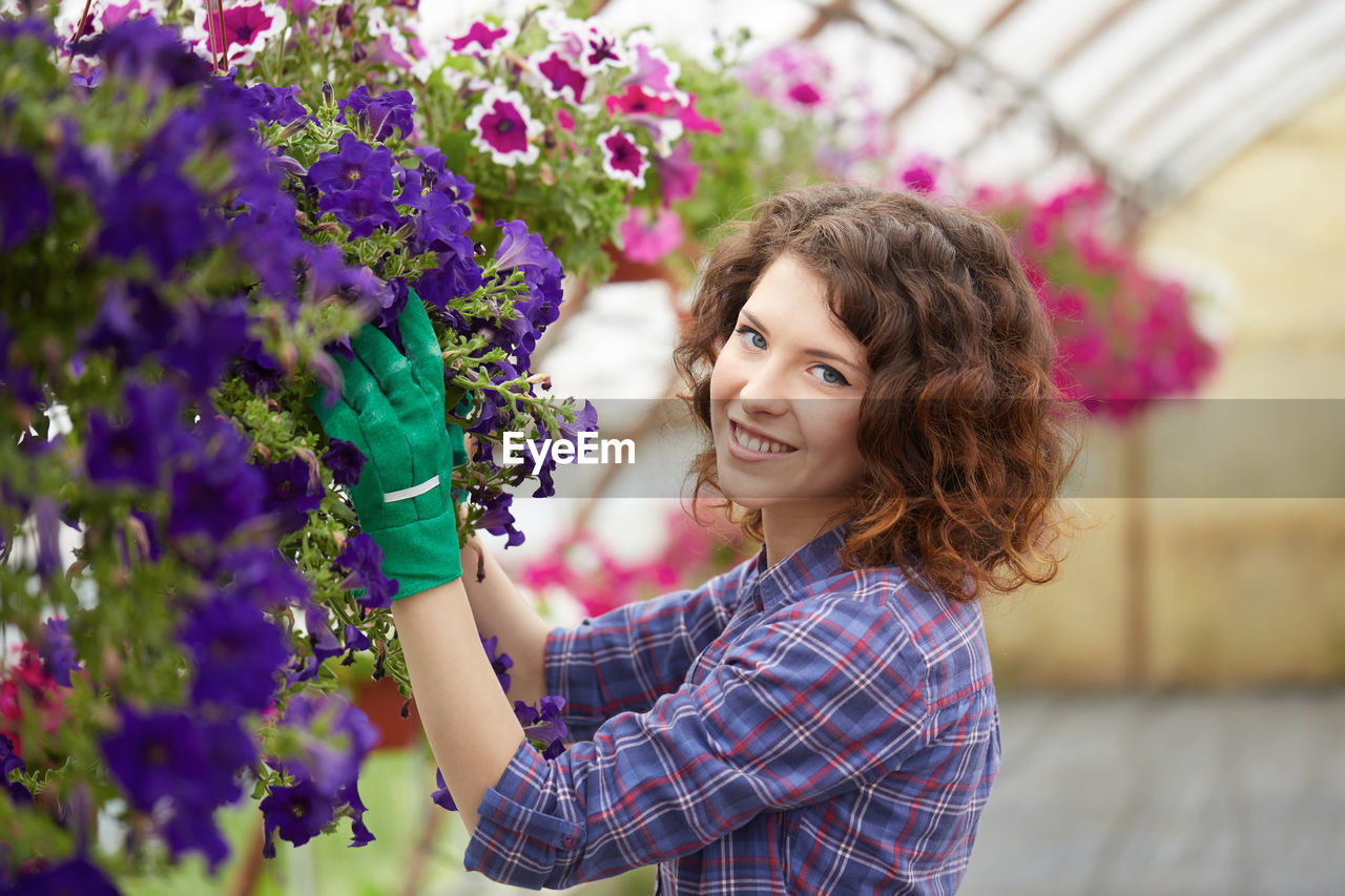 Close-up of woman by purple flowering plants