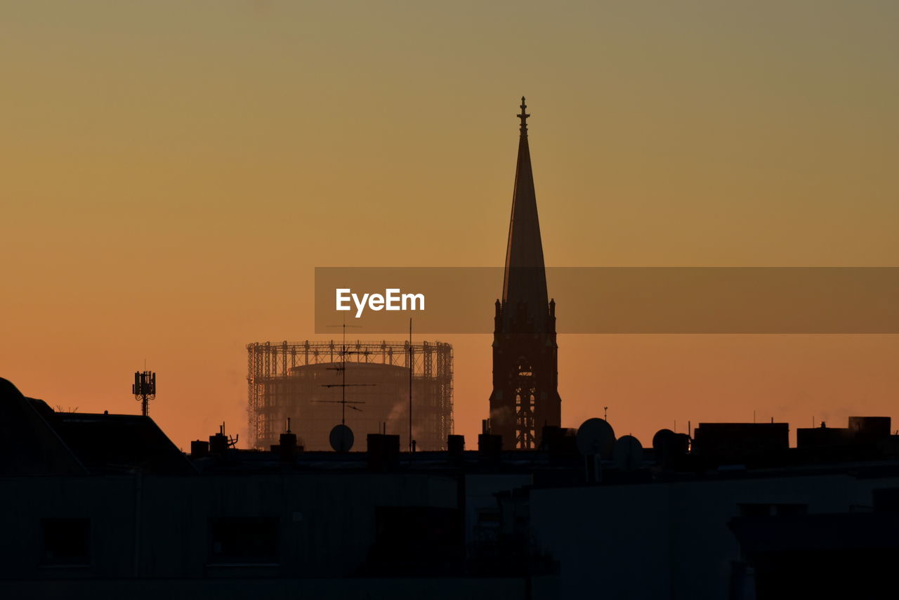 low angle view of buildings against clear sky during sunset