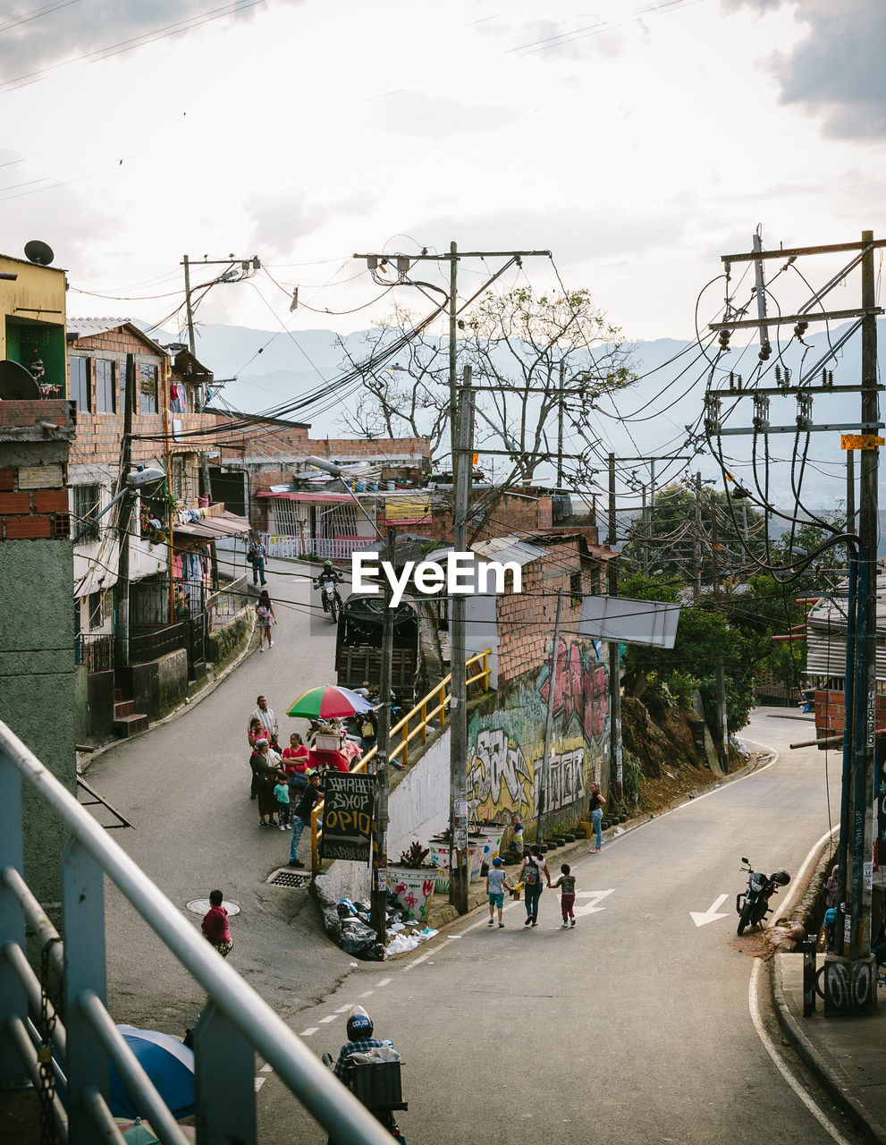 PEOPLE ON ROAD BY BUILDINGS IN CITY