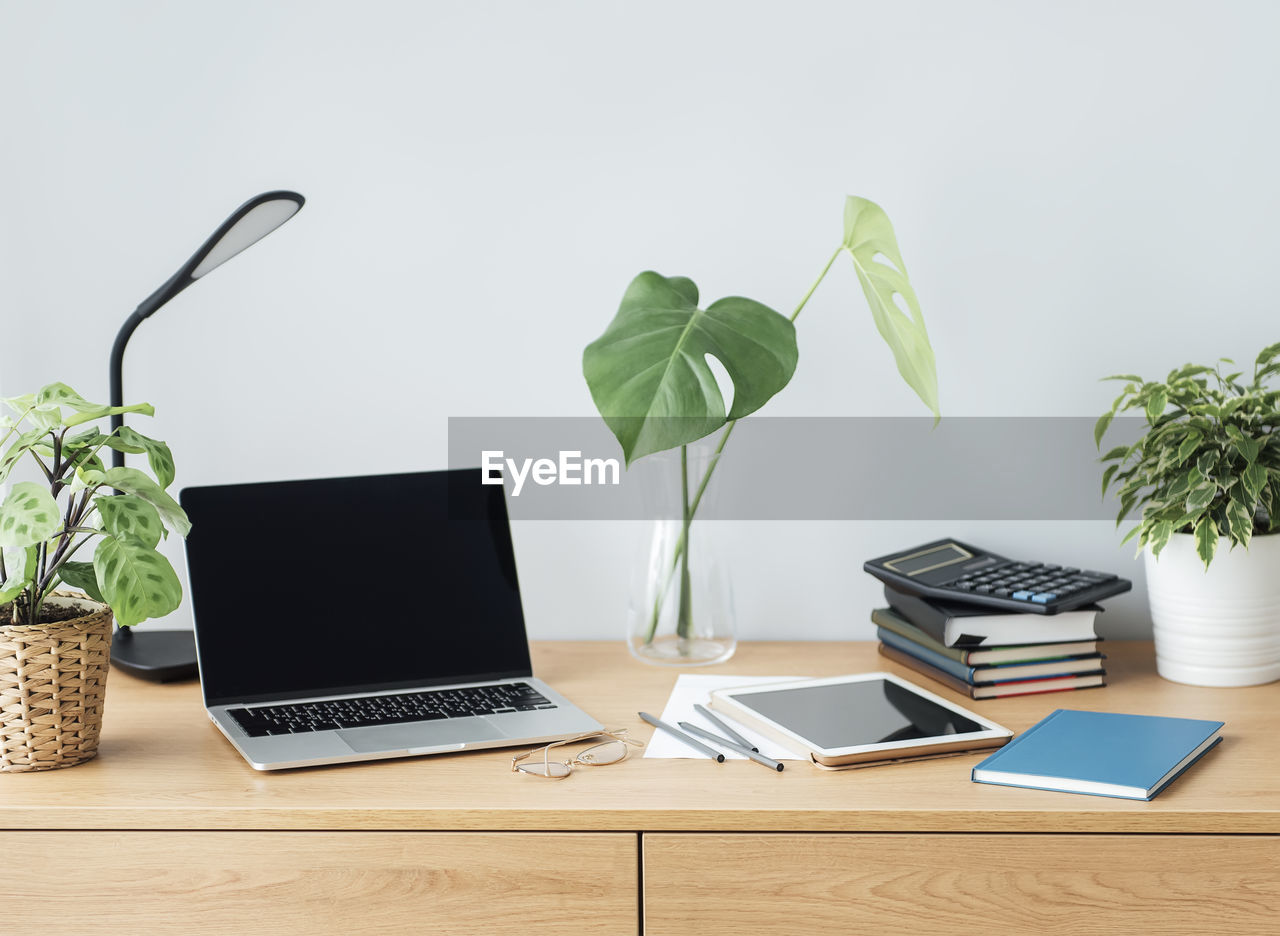 Office workplace with laptop on wooden table