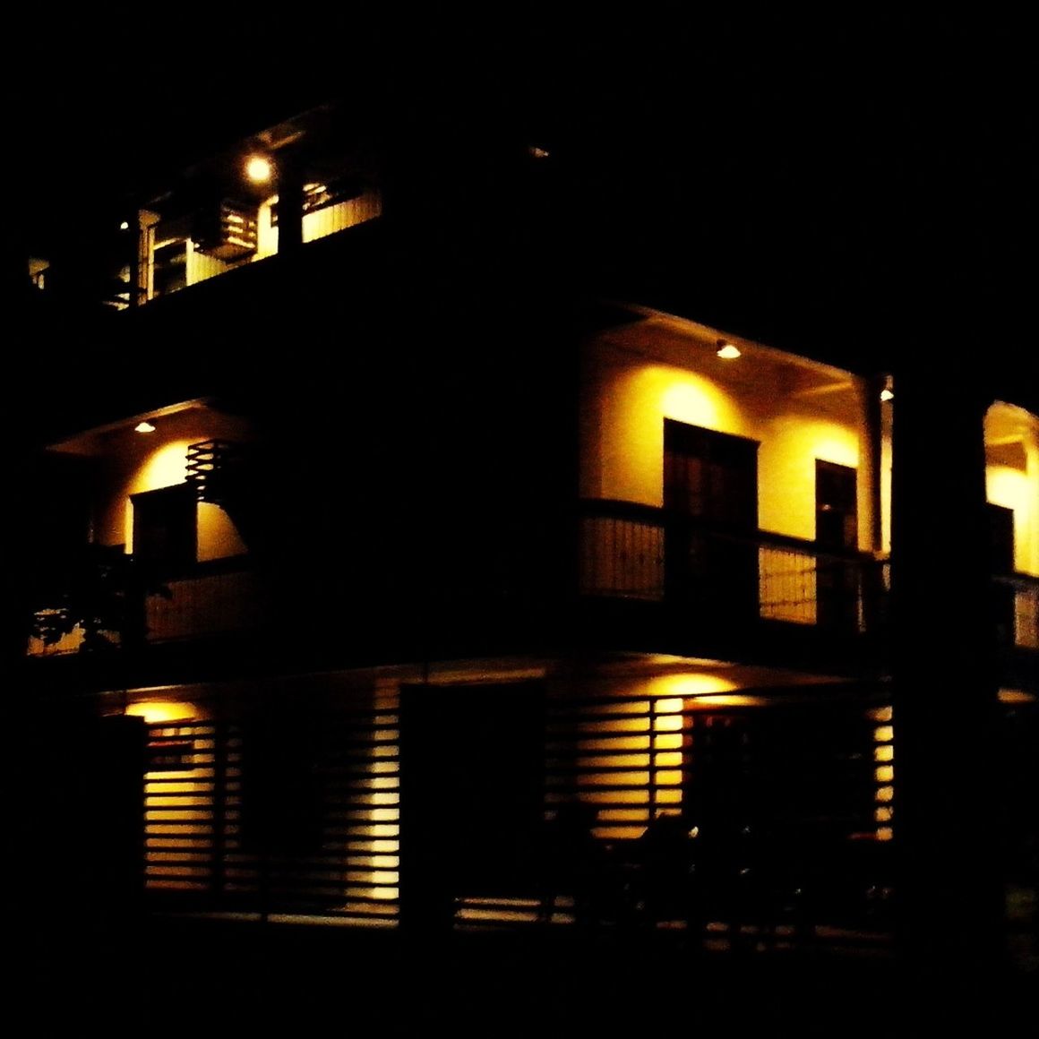 VIEW OF ILLUMINATED BUILDING AT NIGHT