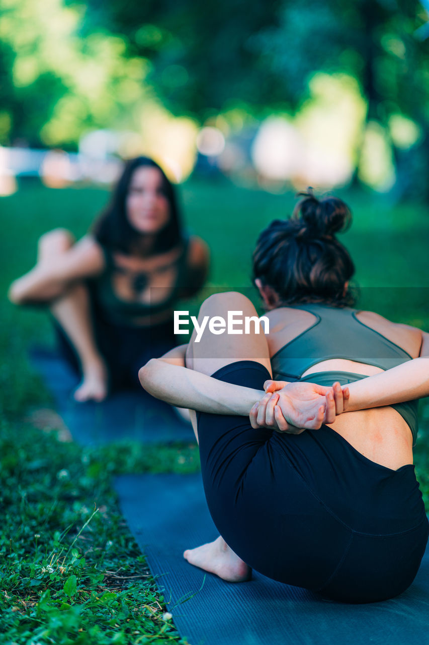 Mindfulness and meditation. women doing yoga by the lake