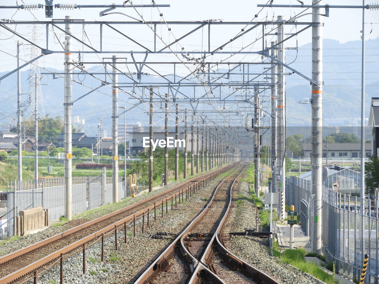 RAILROAD TRACKS BY ELECTRICITY PYLONS