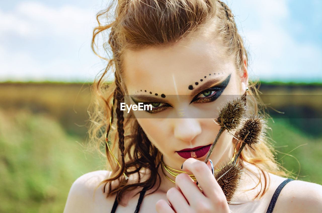 Close-up portrait of young woman with make-up