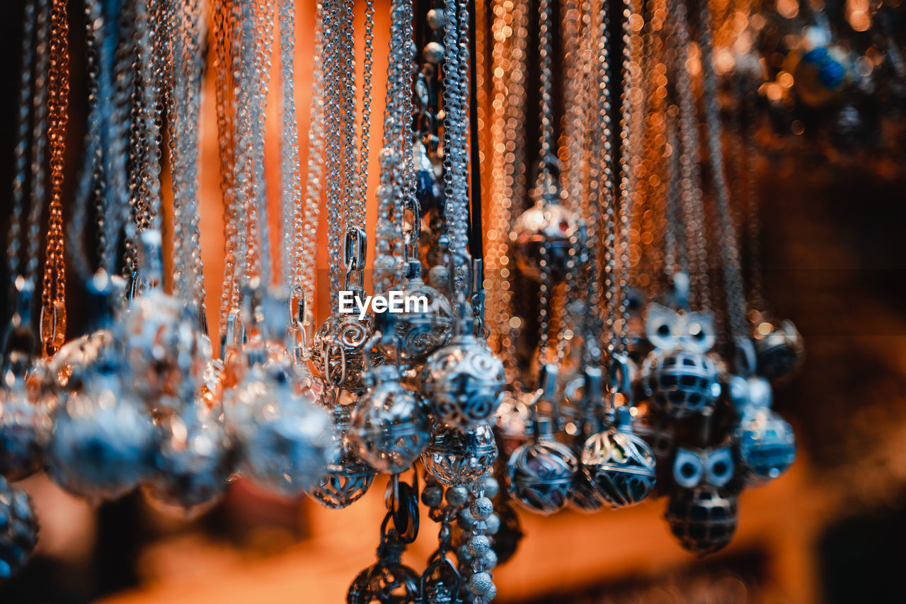 Close-up of decorations hanging on metal for sale