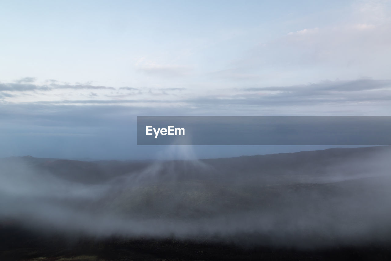 SCENIC VIEW OF FOGGY WEATHER AGAINST SKY