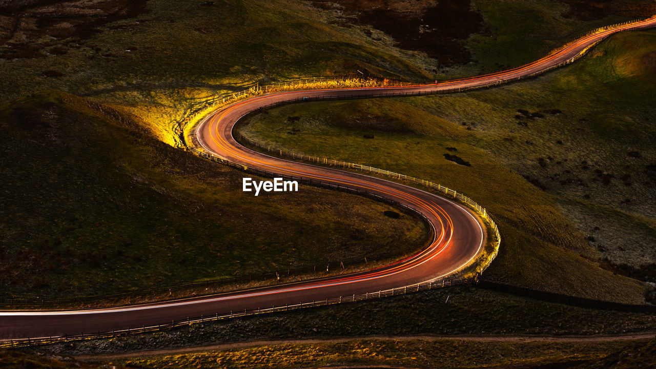 Light trails on mountain road at night