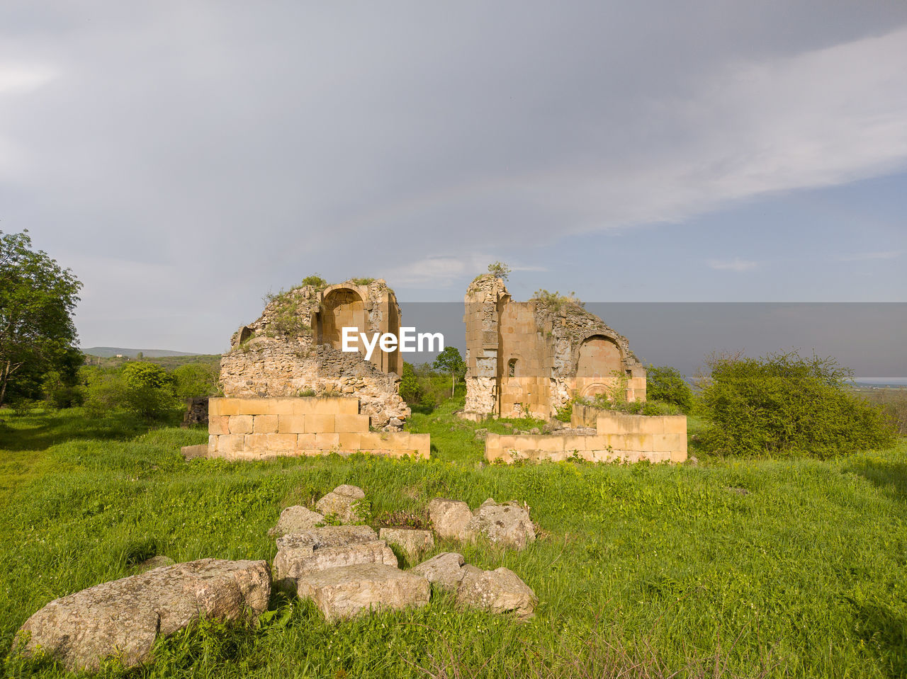 history, the past, ruins, architecture, sky, plant, ancient, old ruin, nature, cloud, grass, travel destinations, built structure, rock, travel, land, no people, building, old, rural area, archaeology, tourism, ruined, stone material, ancient civilization, landscape, fortification, ancient history, outdoors, castle, field, building exterior, environment, day, tree, archaeological site, hill, green, scenics - nature, medieval, tranquility, damaged