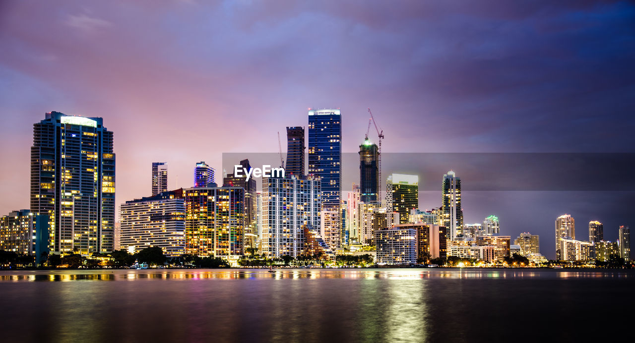 Illuminated cityscape against sky