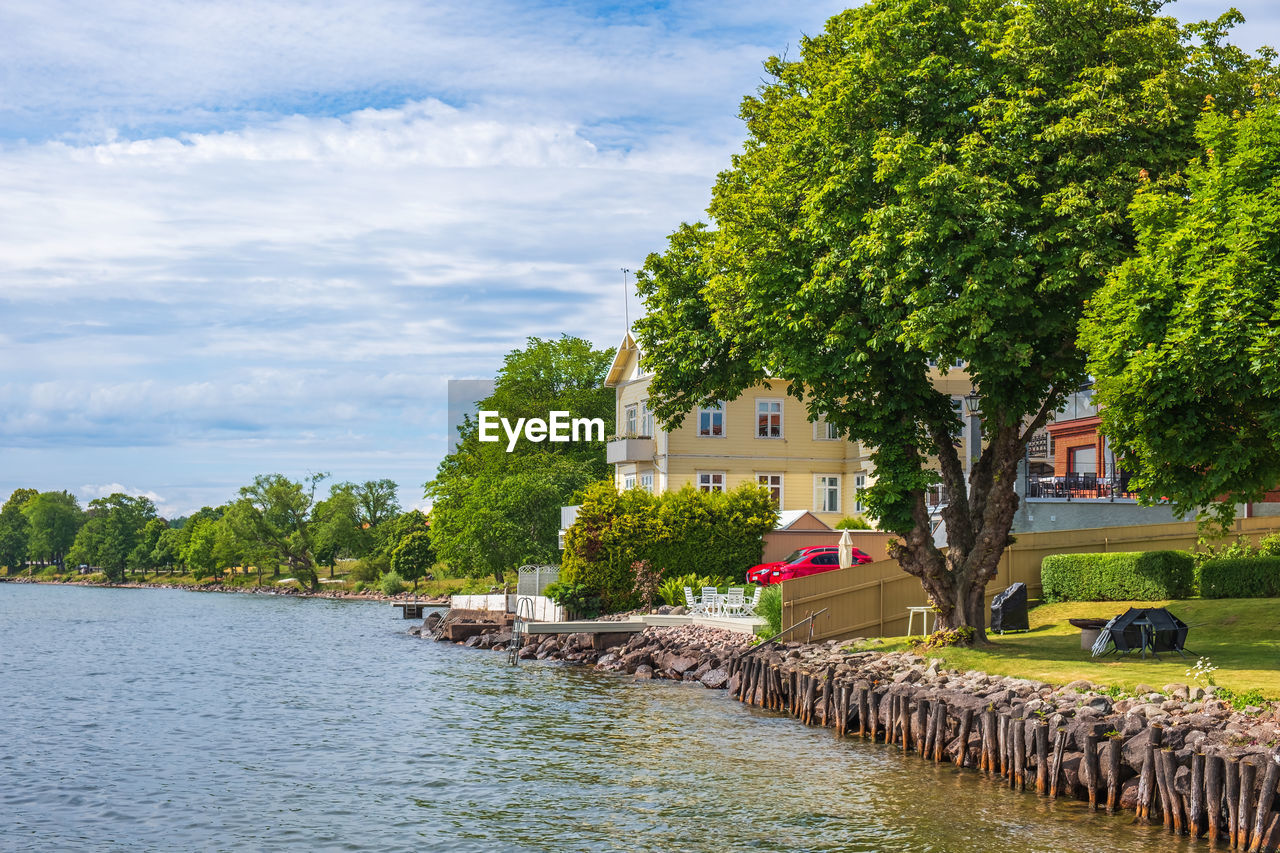 Idyllic view with houses by a lake in summer