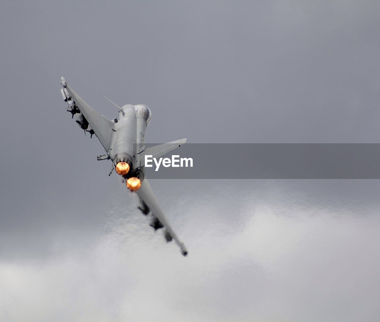 Low angle view of airplane flying against sky