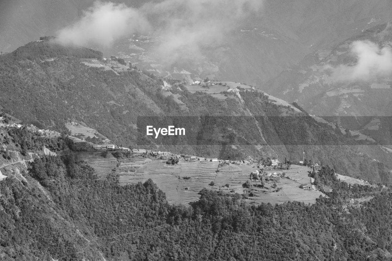 HIGH ANGLE VIEW OF PEOPLE ON MOUNTAIN AGAINST SKY