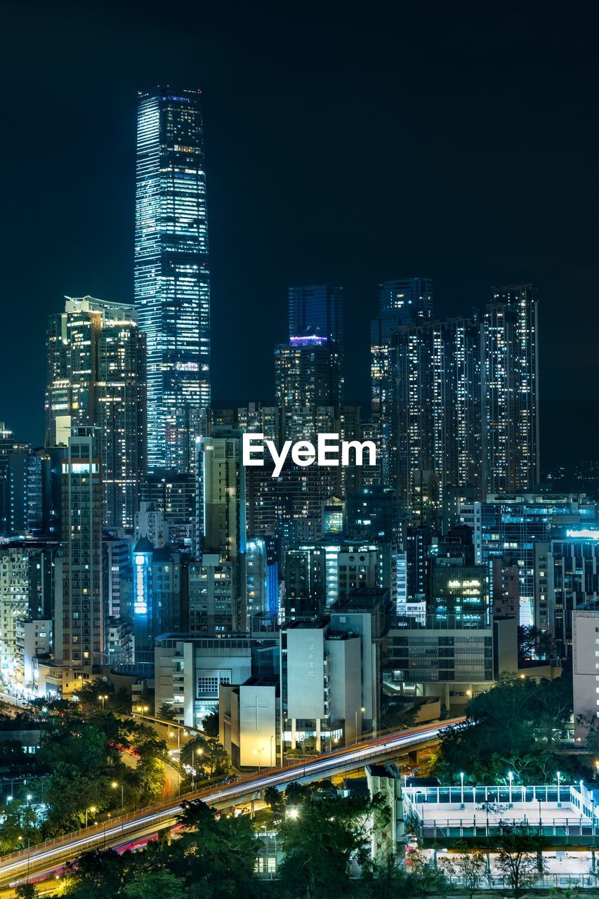 Illuminated buildings against sky at night