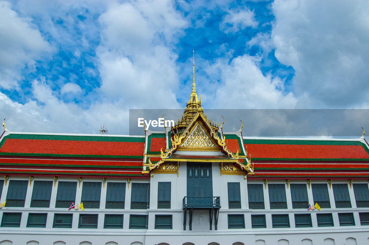 LOW ANGLE VIEW OF TEMPLE BUILDING AGAINST CLOUDY SKY