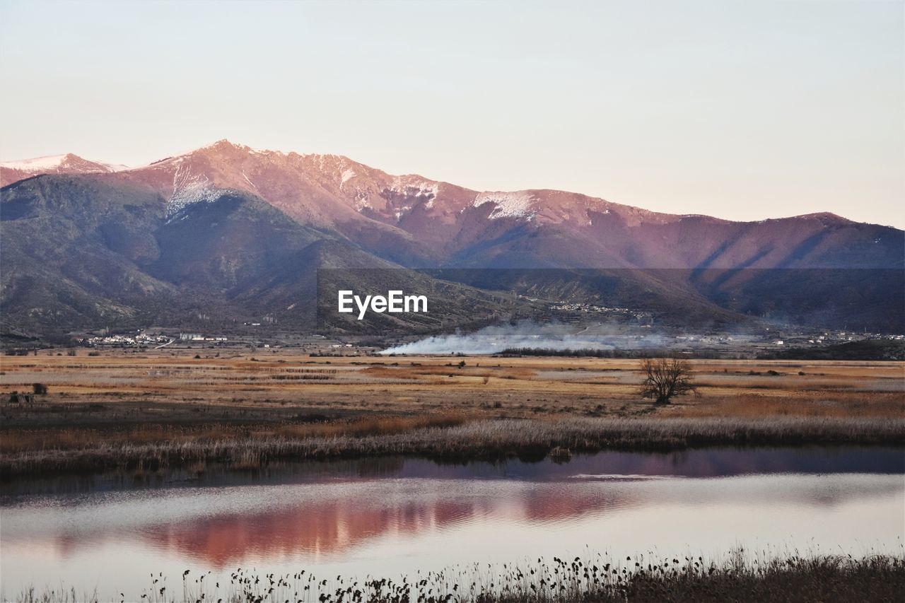 Scenic view of lake and mountains against sky