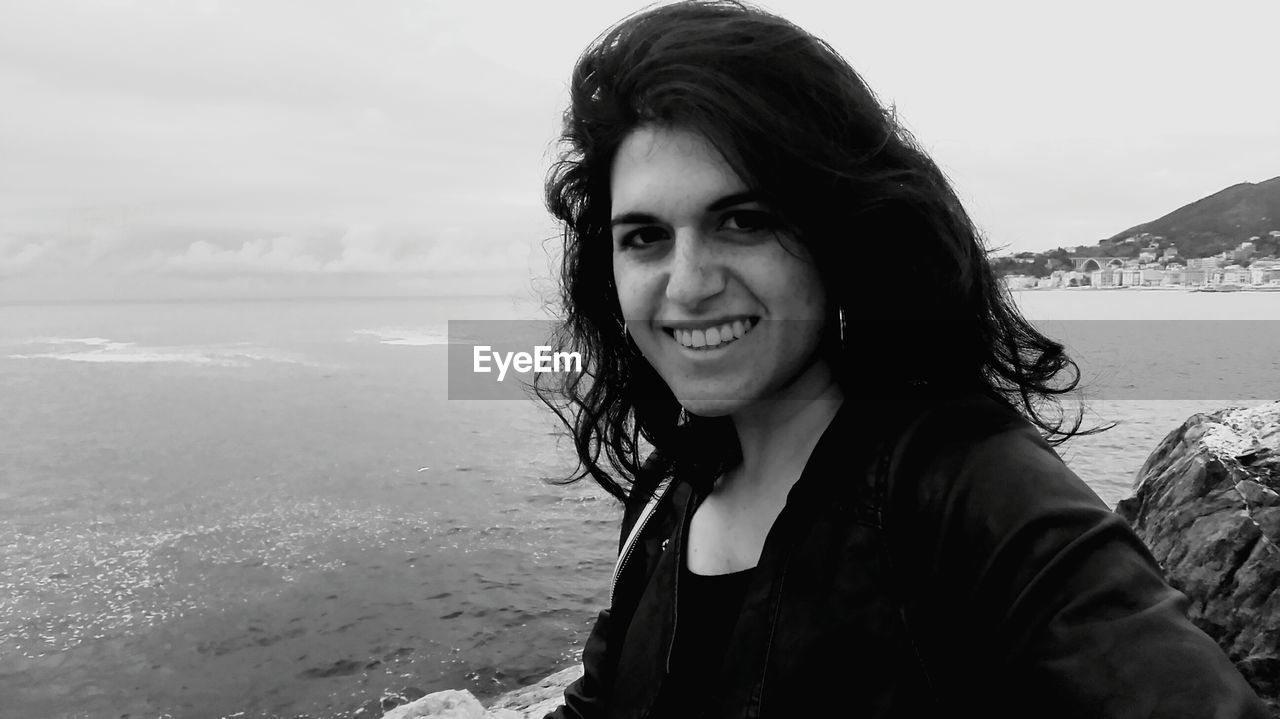 Portrait of smiling young woman at beach