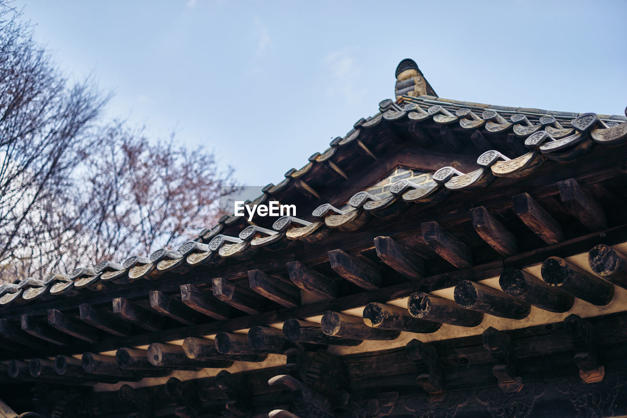 High section of traditional building roof against clear sky