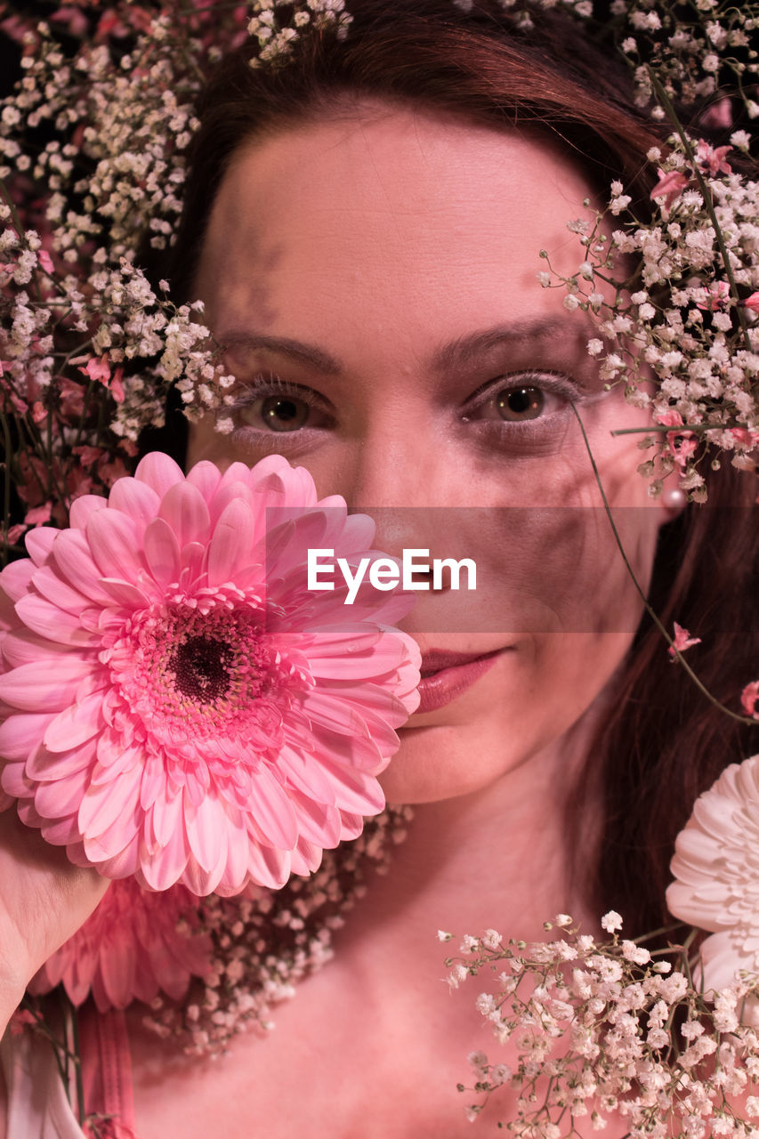 Close-up portrait of beautiful woman with flowers