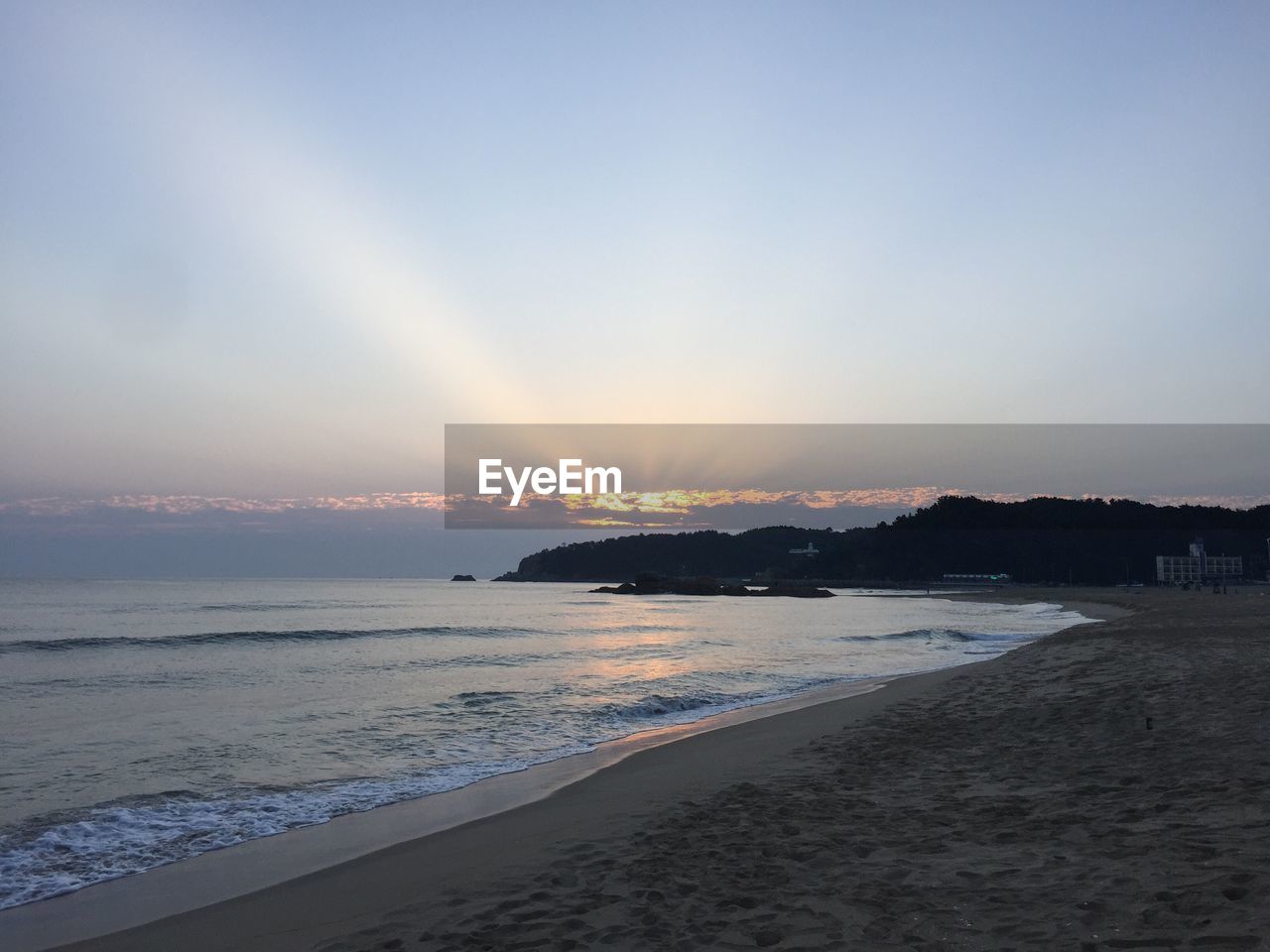 Scenic view of beach against sky during sunset