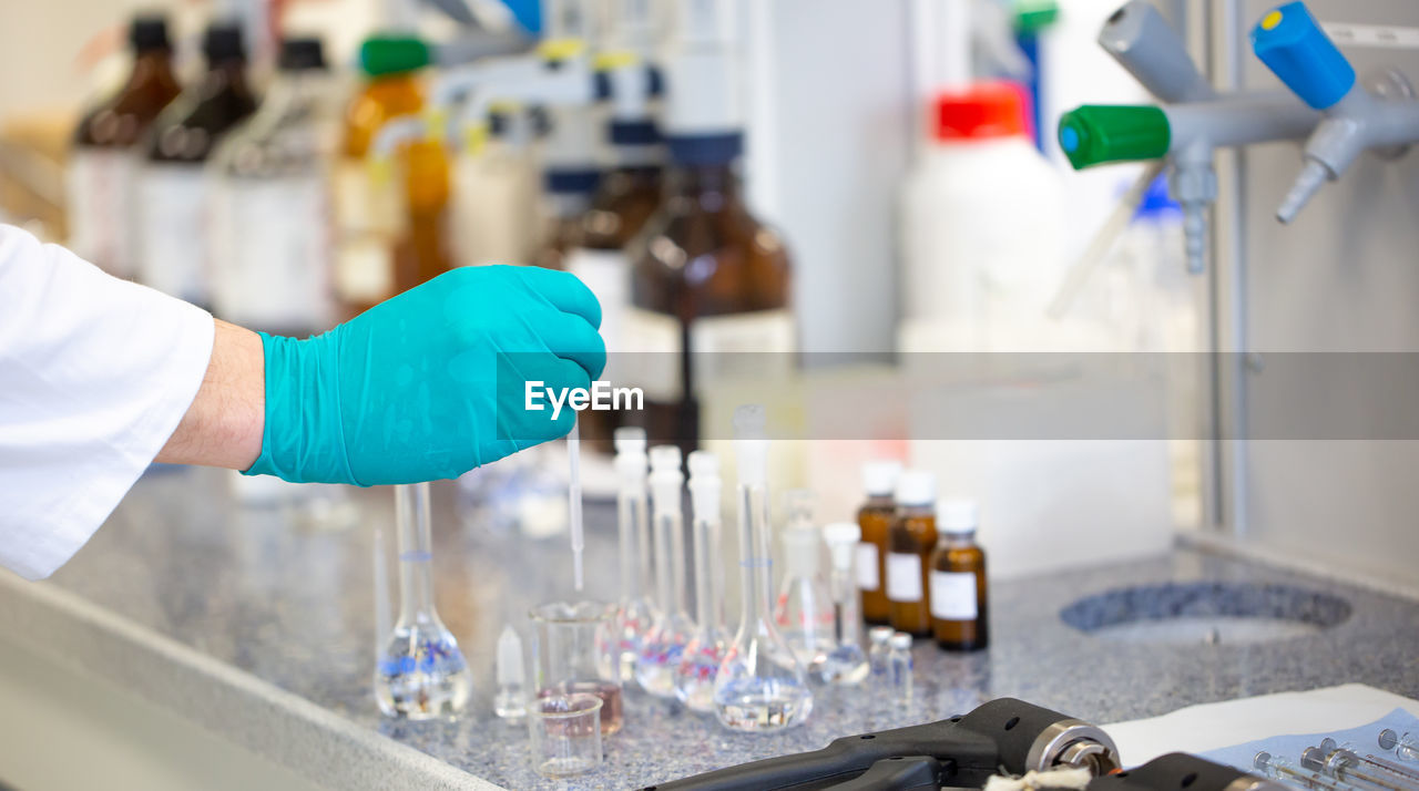 cropped hand of scientist working at clinic