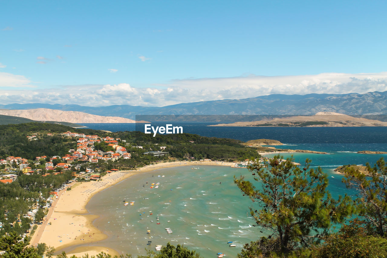 Scenic view of sea and mountains against blue sky