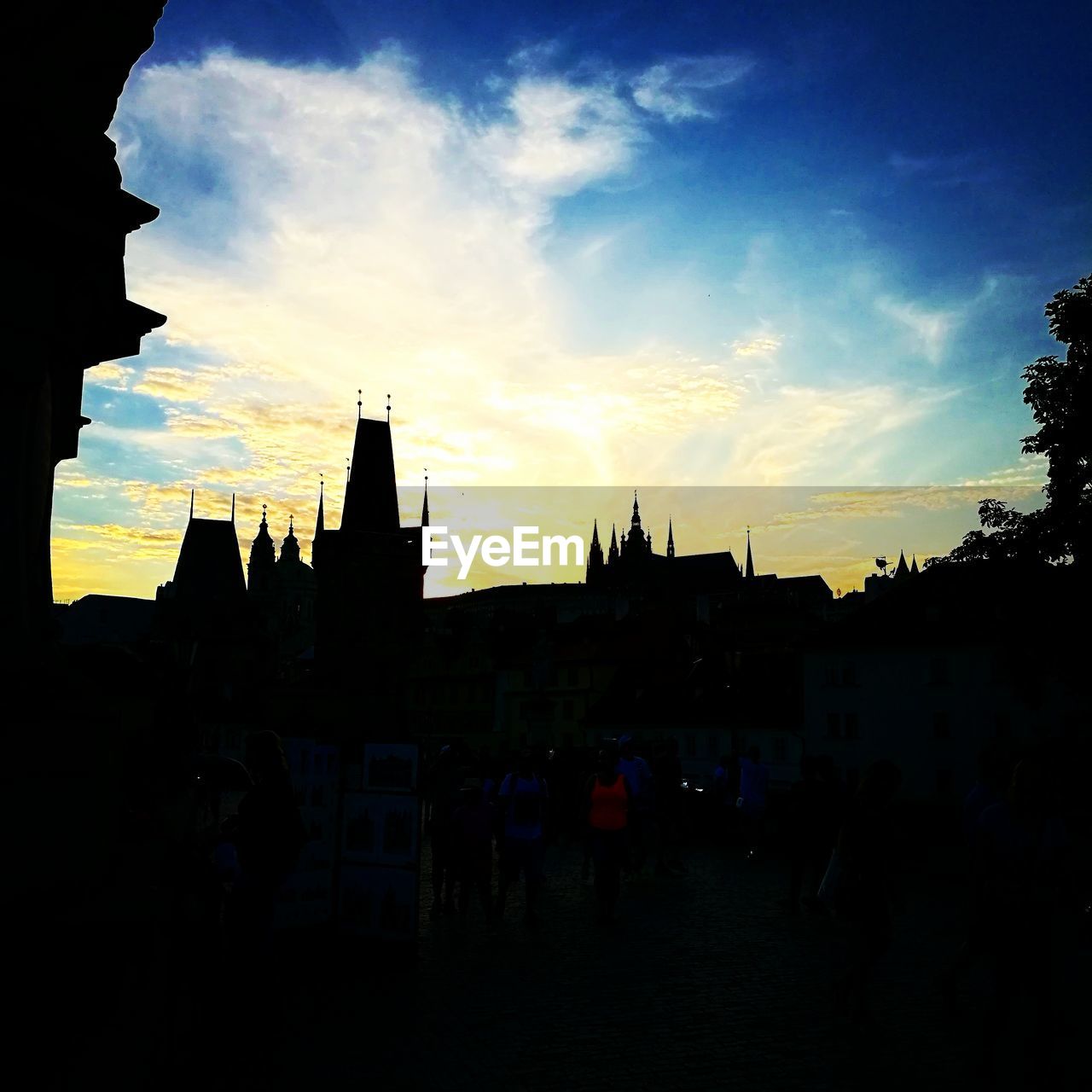 SILHOUETTE OF BUILDINGS AGAINST CLOUDY SKY