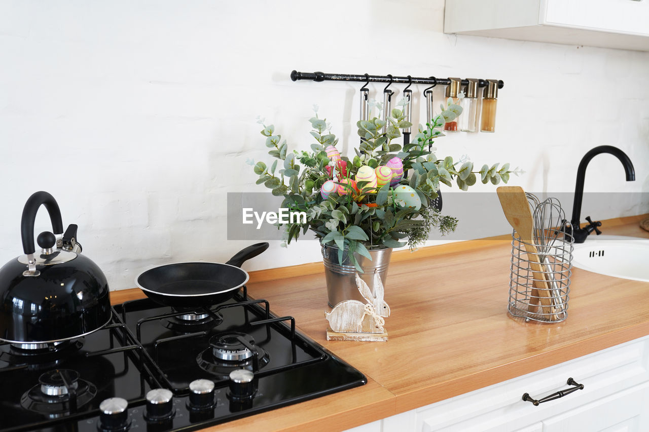 Easter bouquet and eggs on the table in white scandinavian-style kitchen