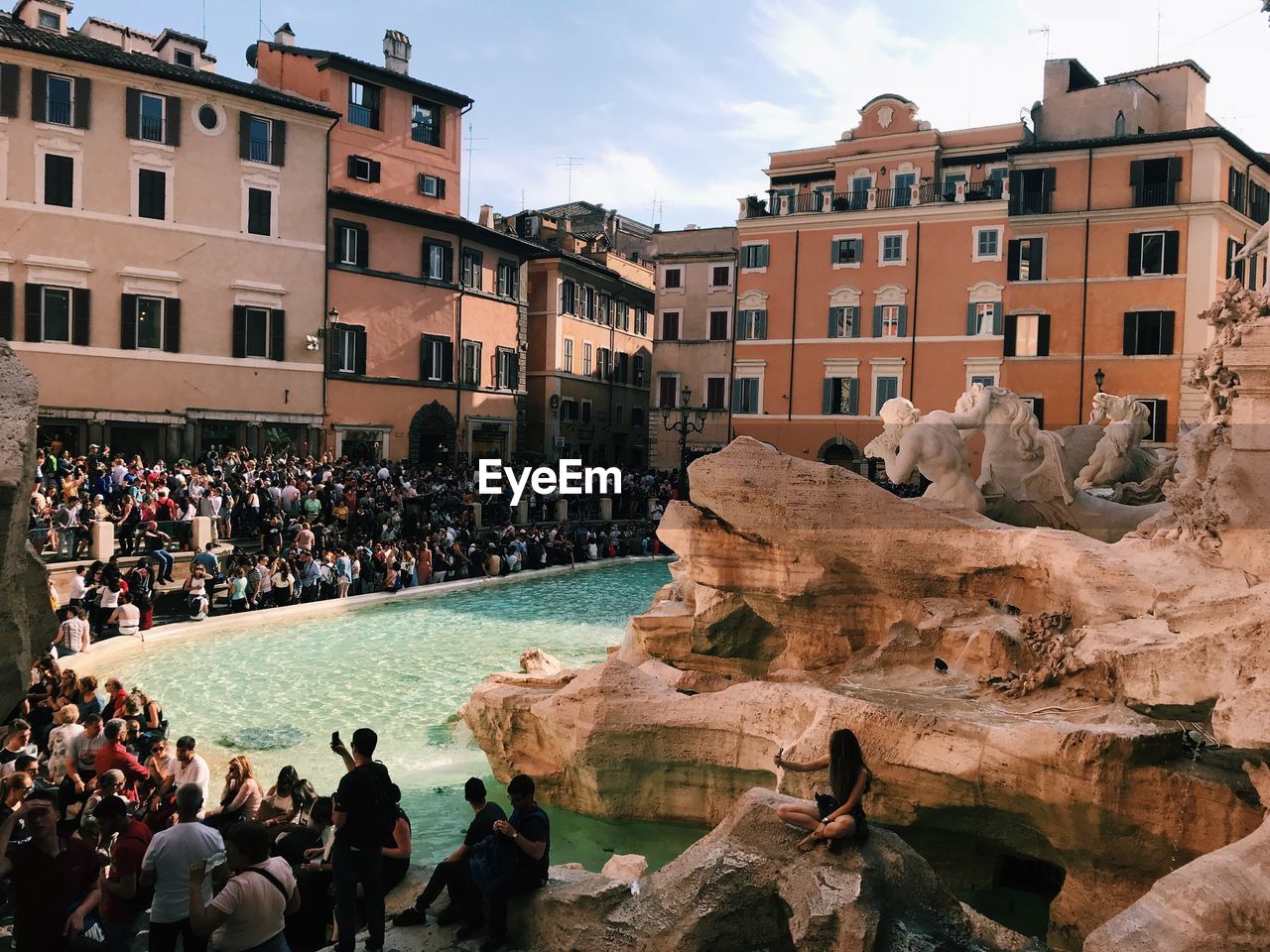 Group of people in front of fountains in city