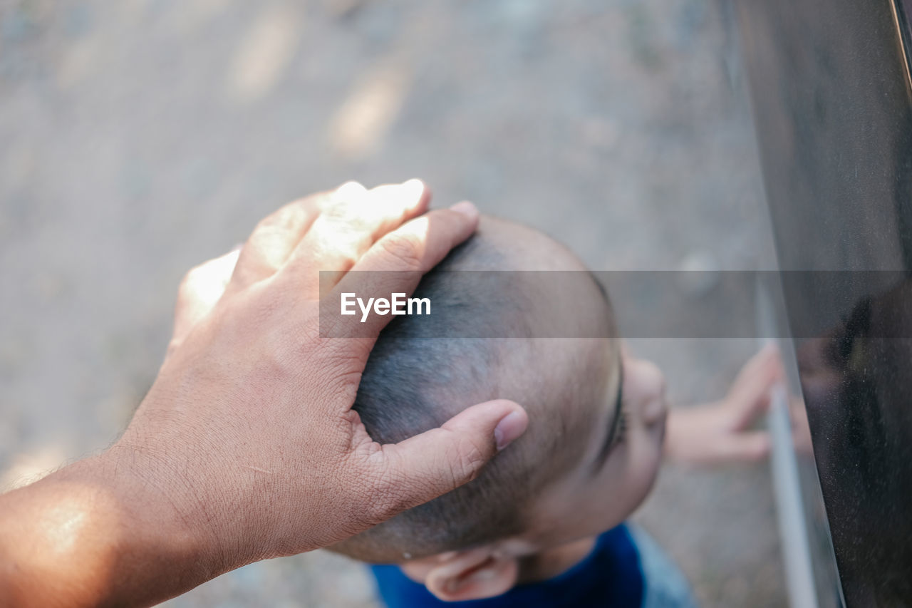 HIGH ANGLE VIEW OF HUMAN HAND HOLDING BLURRED MOTION