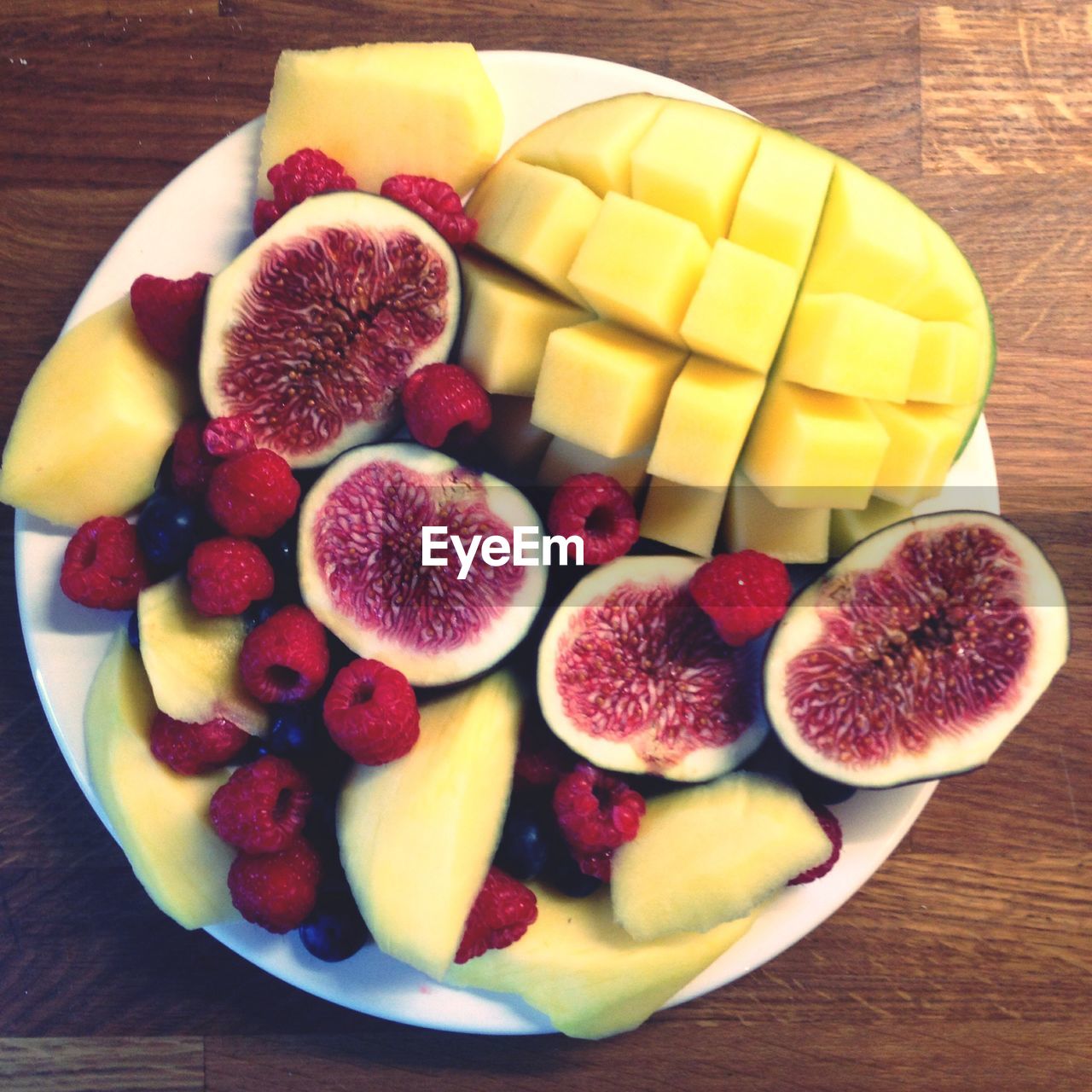 High angle view of various fruits in plate on table