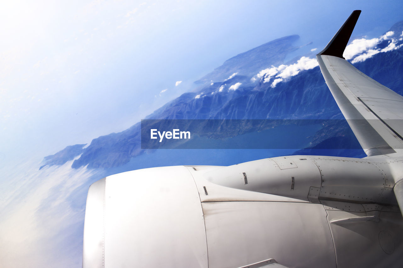 VIEW OF AIRPLANE WING OVER CLOUDS