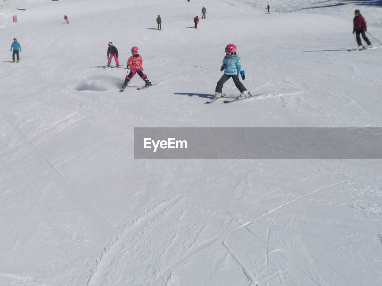People skiing on snow covered field