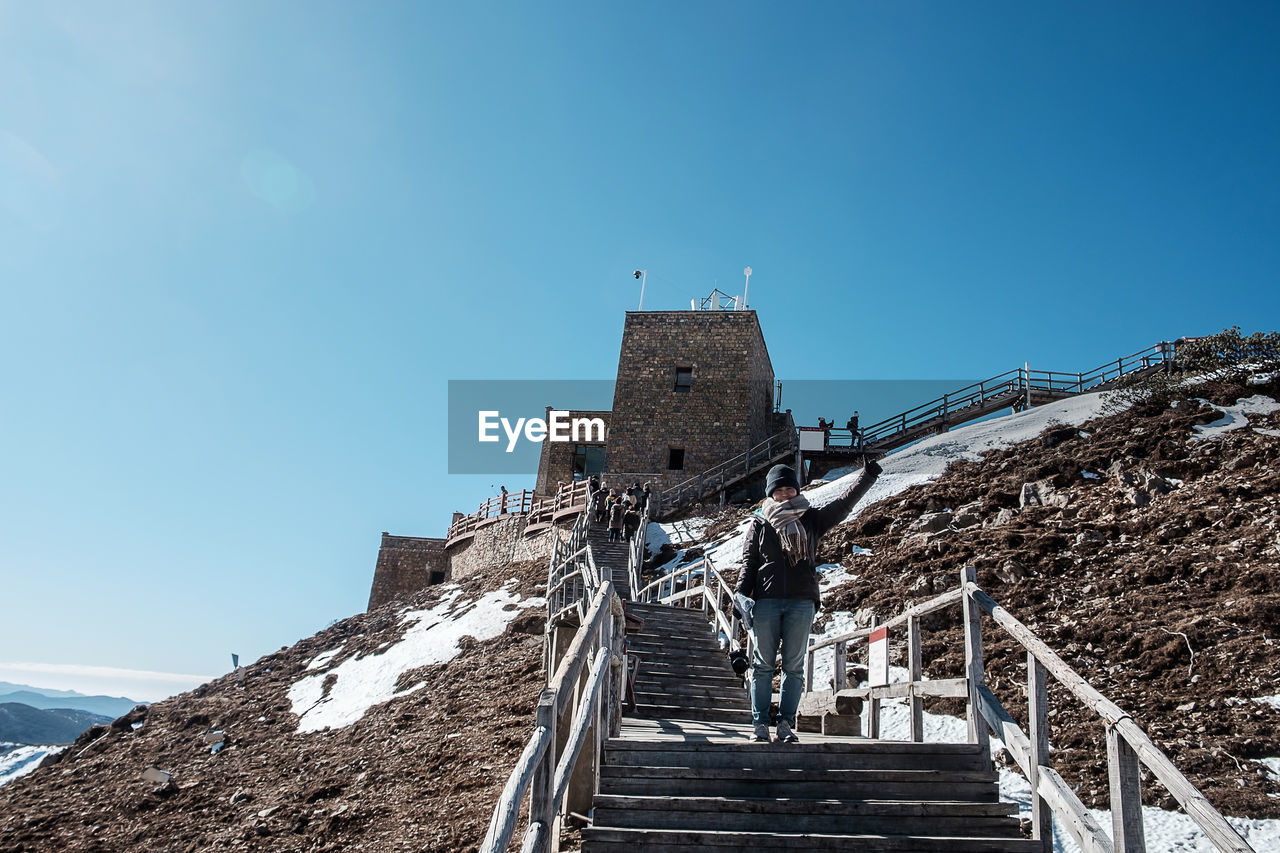 LOW ANGLE VIEW OF OLD BUILDING AGAINST CLEAR SKY DURING WINTER