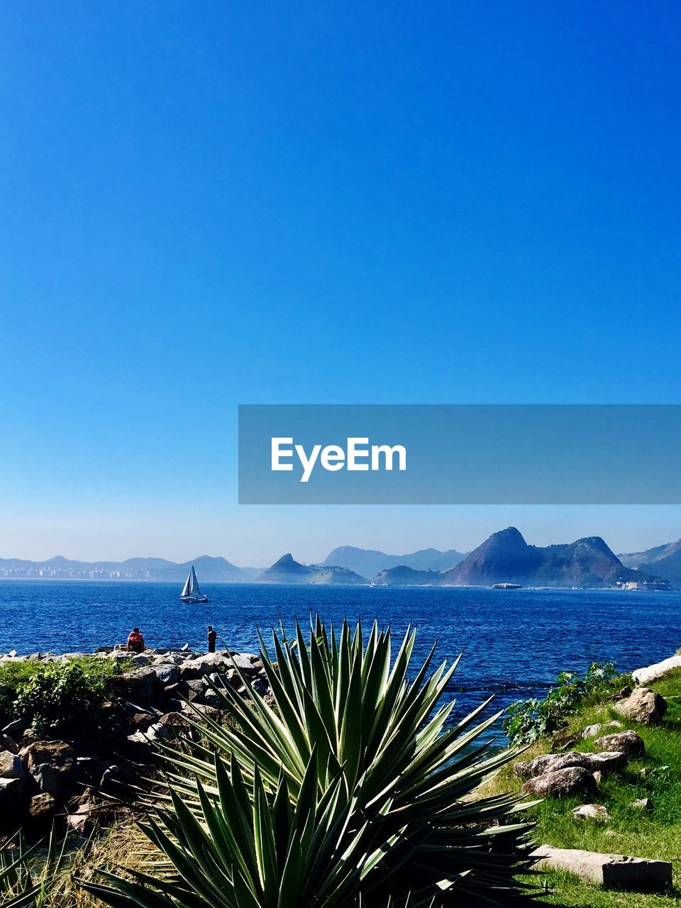 Scenic view of sea against clear blue sky