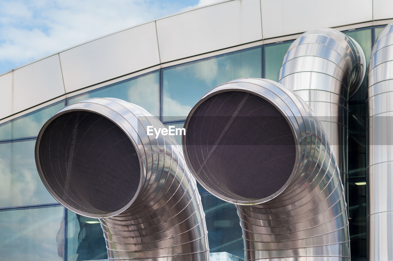 LOW ANGLE VIEW OF SMOKE STACKS