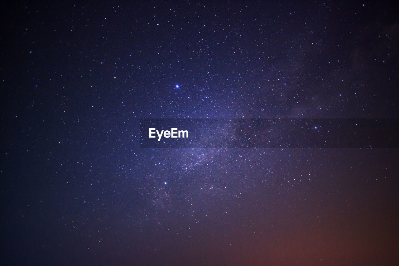 LOW ANGLE VIEW OF STAR FIELD AGAINST SKY