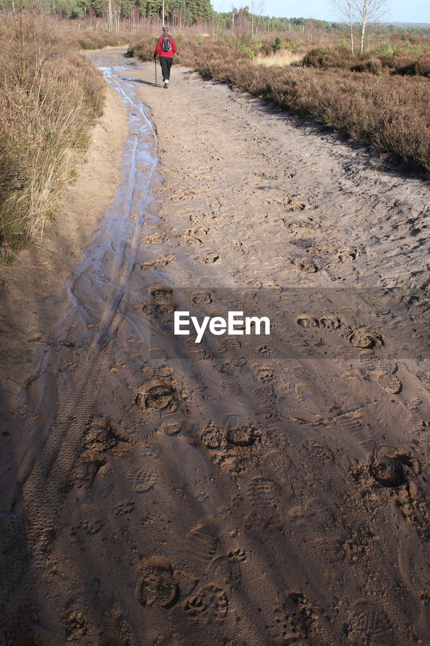 MAN WALKING IN SAND