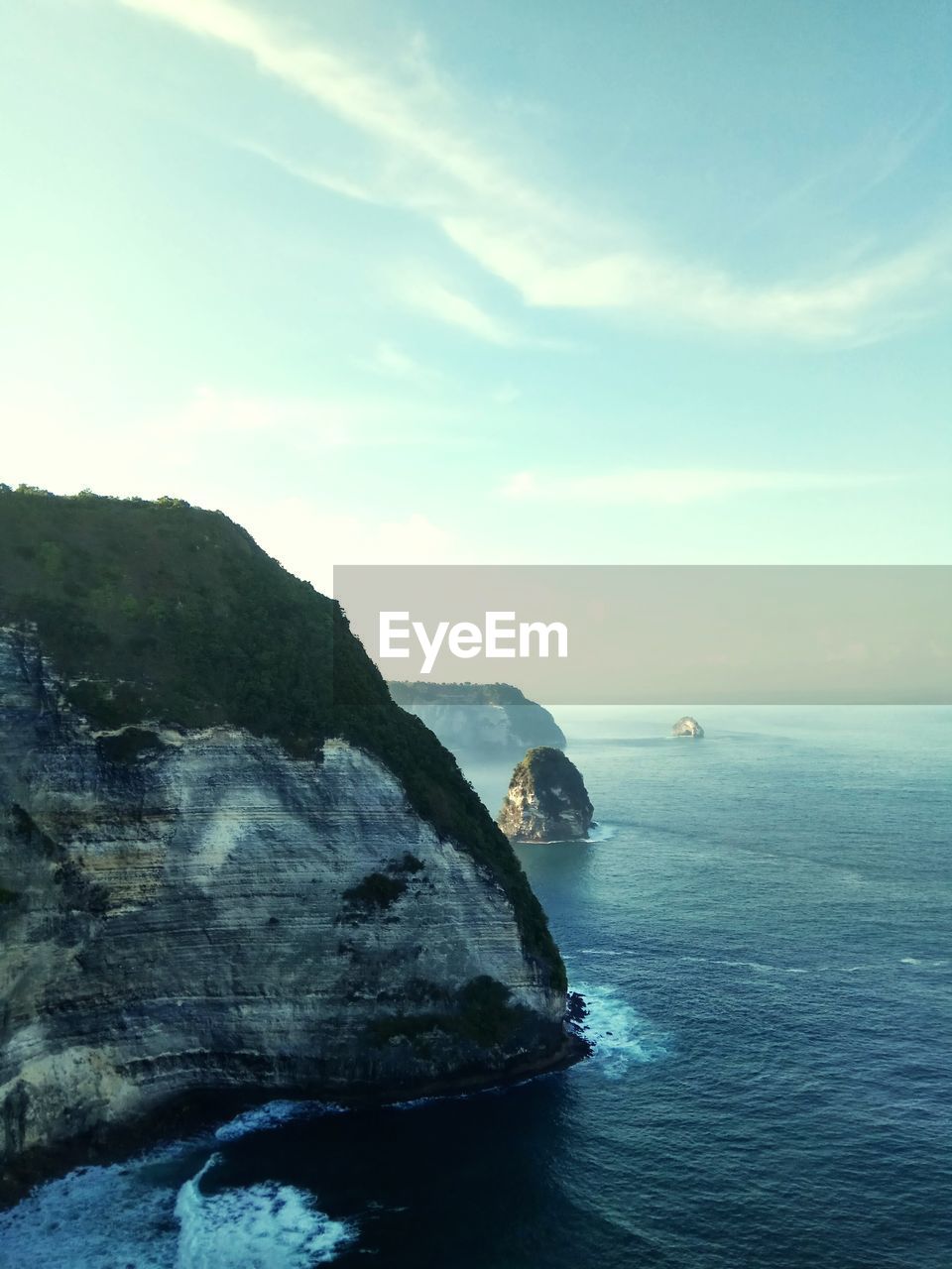 Rock formations in sea against sky