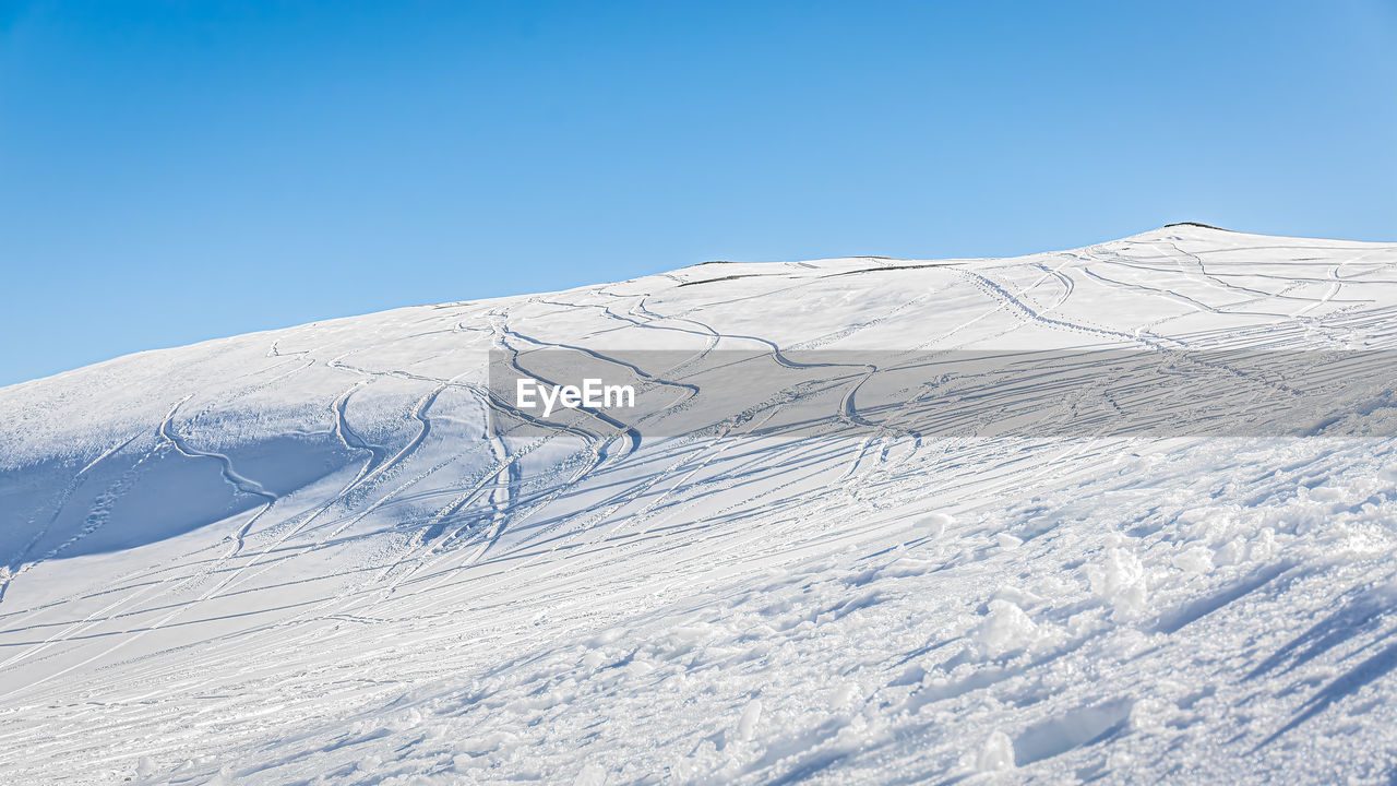 SNOWCAPPED MOUNTAINS AGAINST CLEAR BLUE SKY