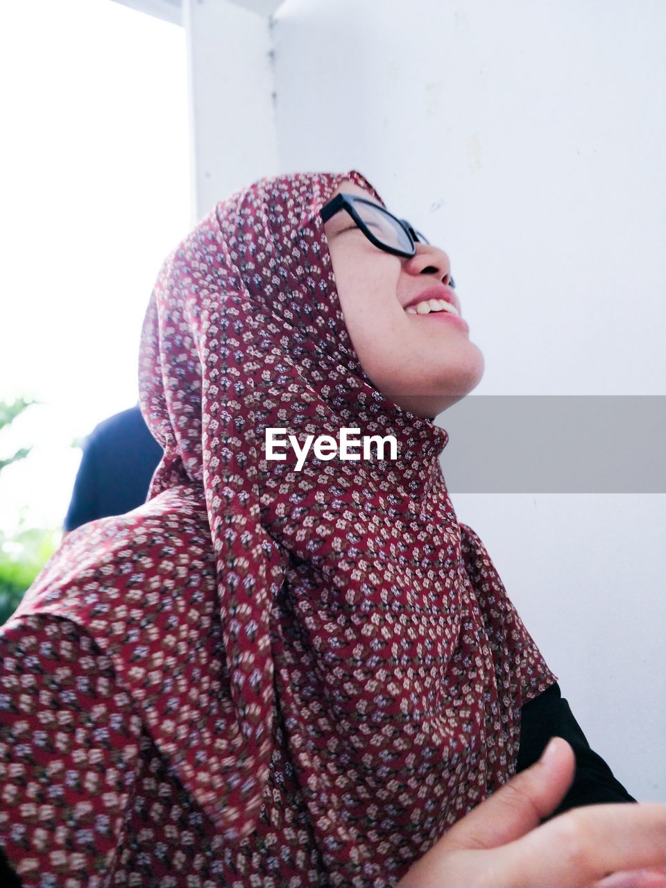 Smiling woman wearing eyeglasses and hijab