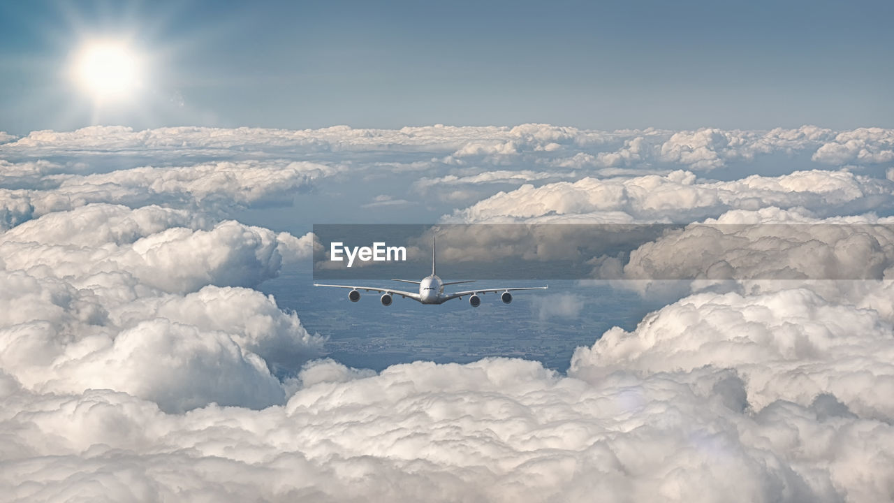 Exterior view of an airplane flying over the clouds