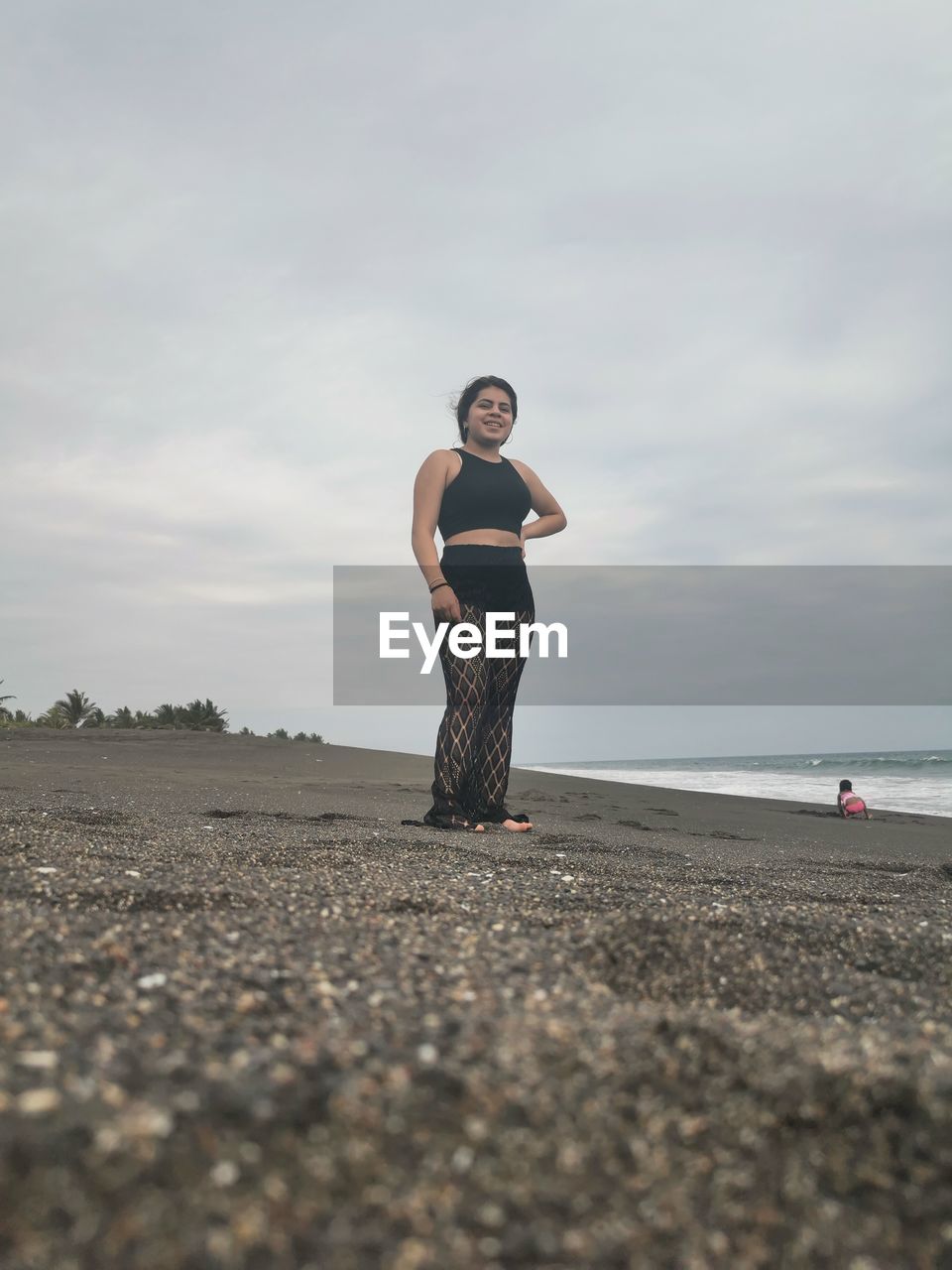 FULL LENGTH OF WOMAN STANDING ON BEACH