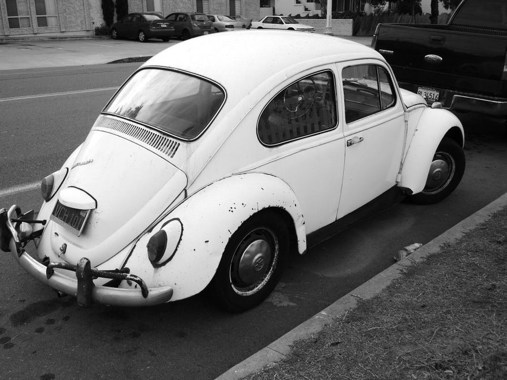 CLOSE-UP OF VINTAGE CAR ON STREET