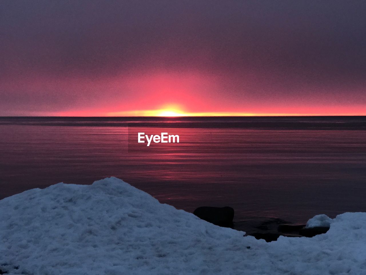 SCENIC VIEW OF SEA AGAINST ORANGE SKY DURING SUNSET