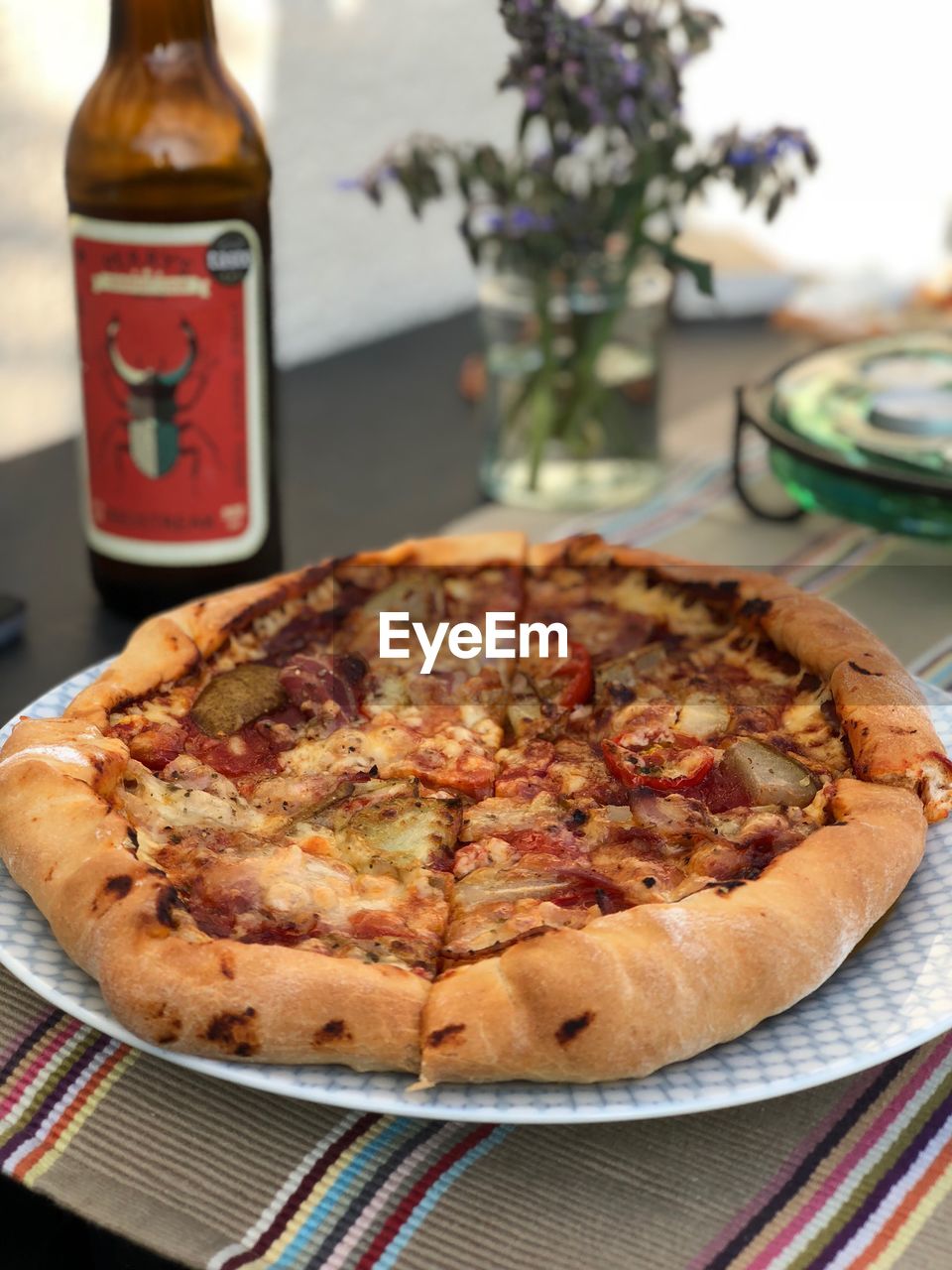 CLOSE-UP OF PIZZA SERVED ON TABLE