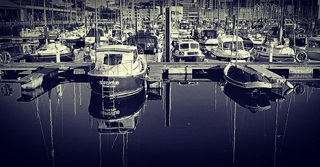 BOATS MOORED IN HARBOR